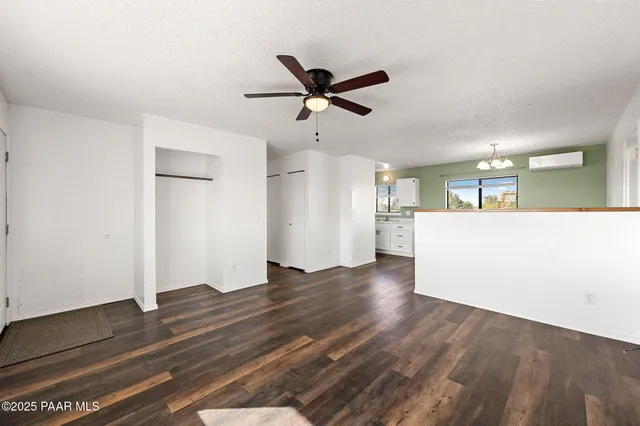 a view of a kitchen with wooden floor and a ceiling fan