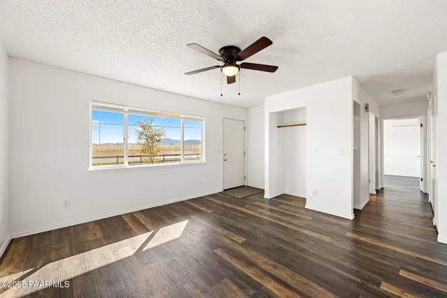 a view of wooden floor and windows in a room
