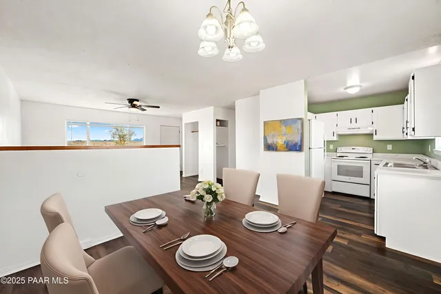 an empty room with wooden floor and window