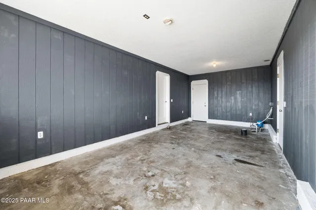 a view of empty room with wooden ceiling