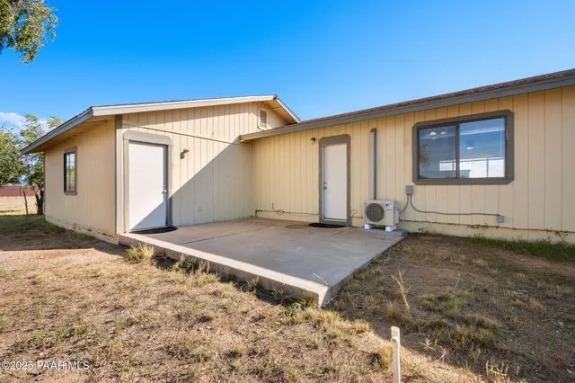 a view of a backyard with sitting area