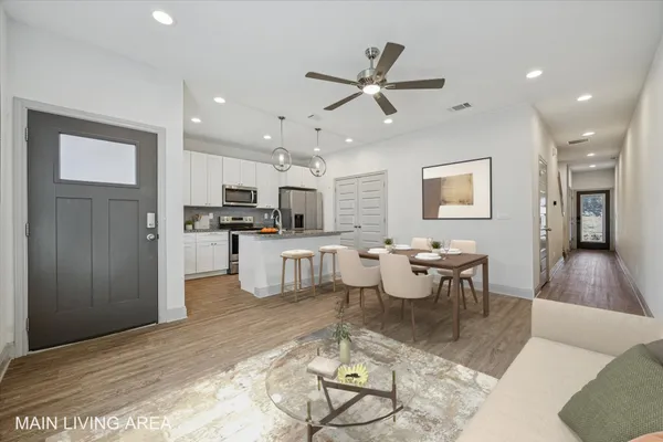 a living room with furniture and kitchen view