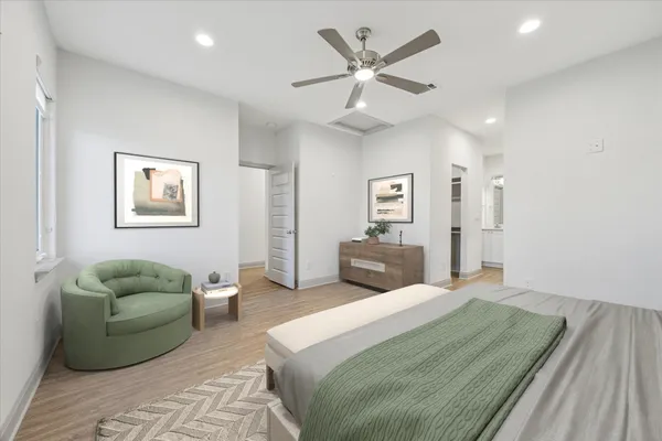 an empty room with wooden floor ceiling fan and windows