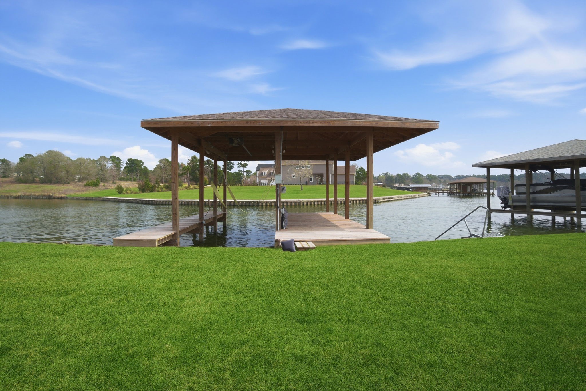 255 Peninsula Drive Livingston, TX 77351 - Photo 46 of 50 10’ x 26’ boathouse and slip with electronic lift attached to a shaded and roofed deck with a kayak launch pad.