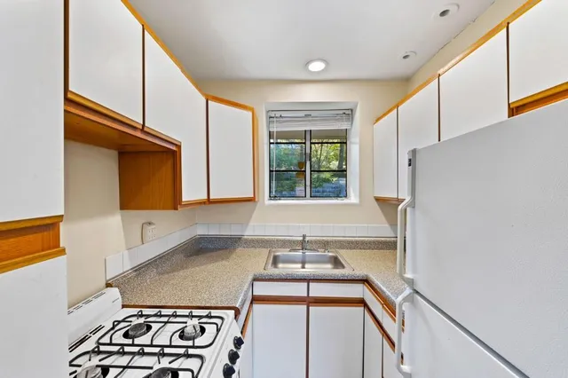 a kitchen with a refrigerator and a stove