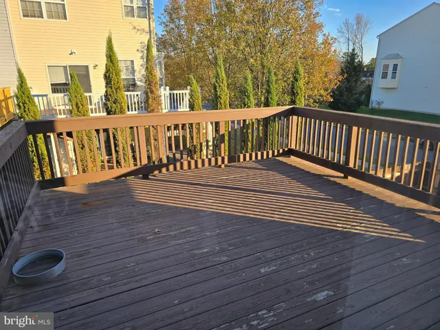 a view of a wooden bench on the roof deck