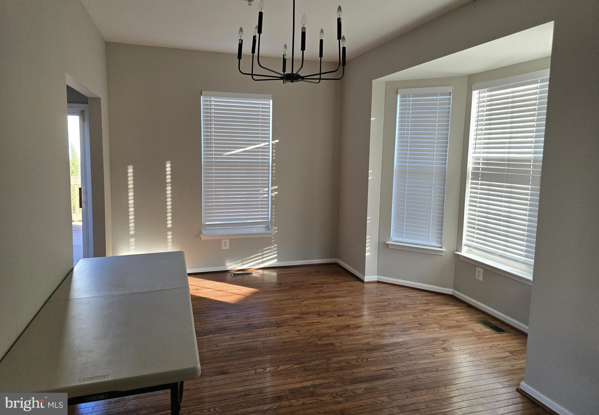 4146 Cutty Sark Road Middle River, MD 21220 - Photo 3 of 13 a view of an empty room with wooden floor and a window