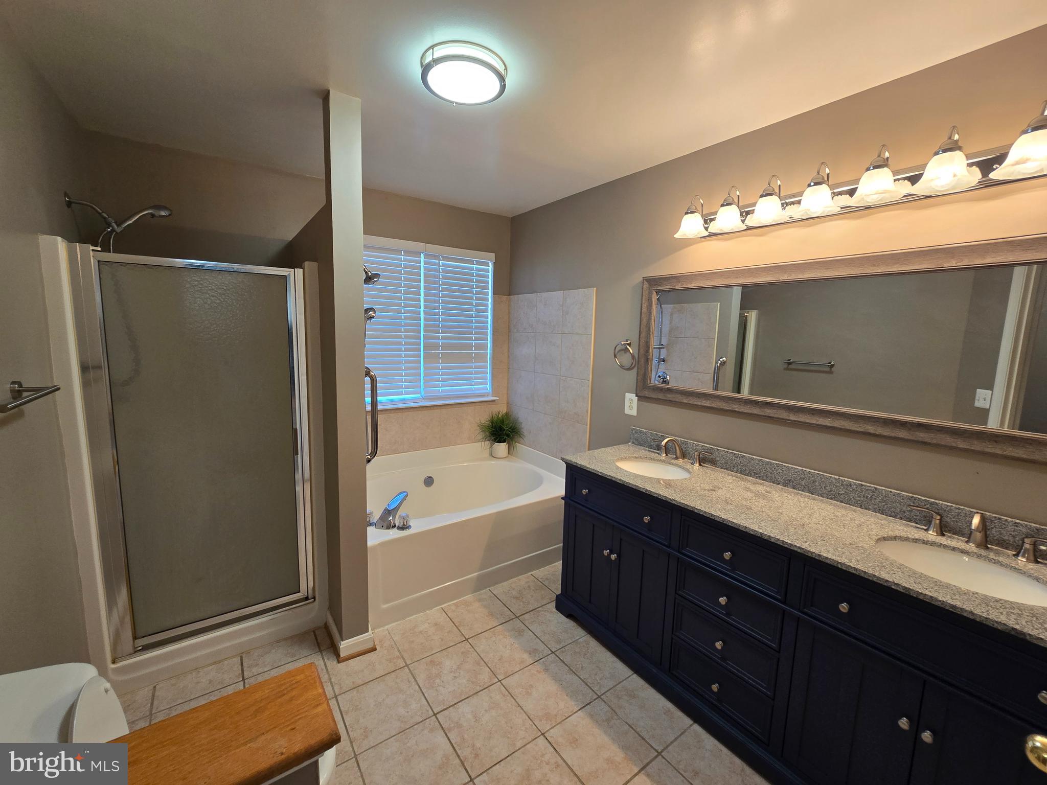4146 Cutty Sark Road Middle River, MD 21220 - Photo 7 of 13 a bathroom with a tub sink double vanity and mirror