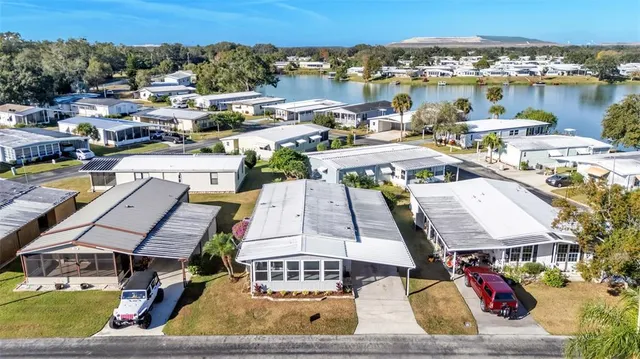 an aerial view of a house with outdoor seating