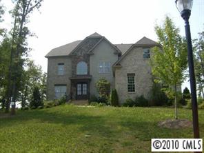 2718 Old Course Road Monroe, NC 28112 - Photo 1 of 8 a brick house with a big yard and potted plants in front of the house