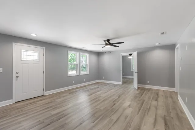wooden floor in an empty room with a window