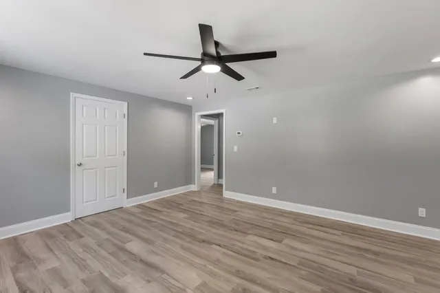 a view of an empty room and wooden floor