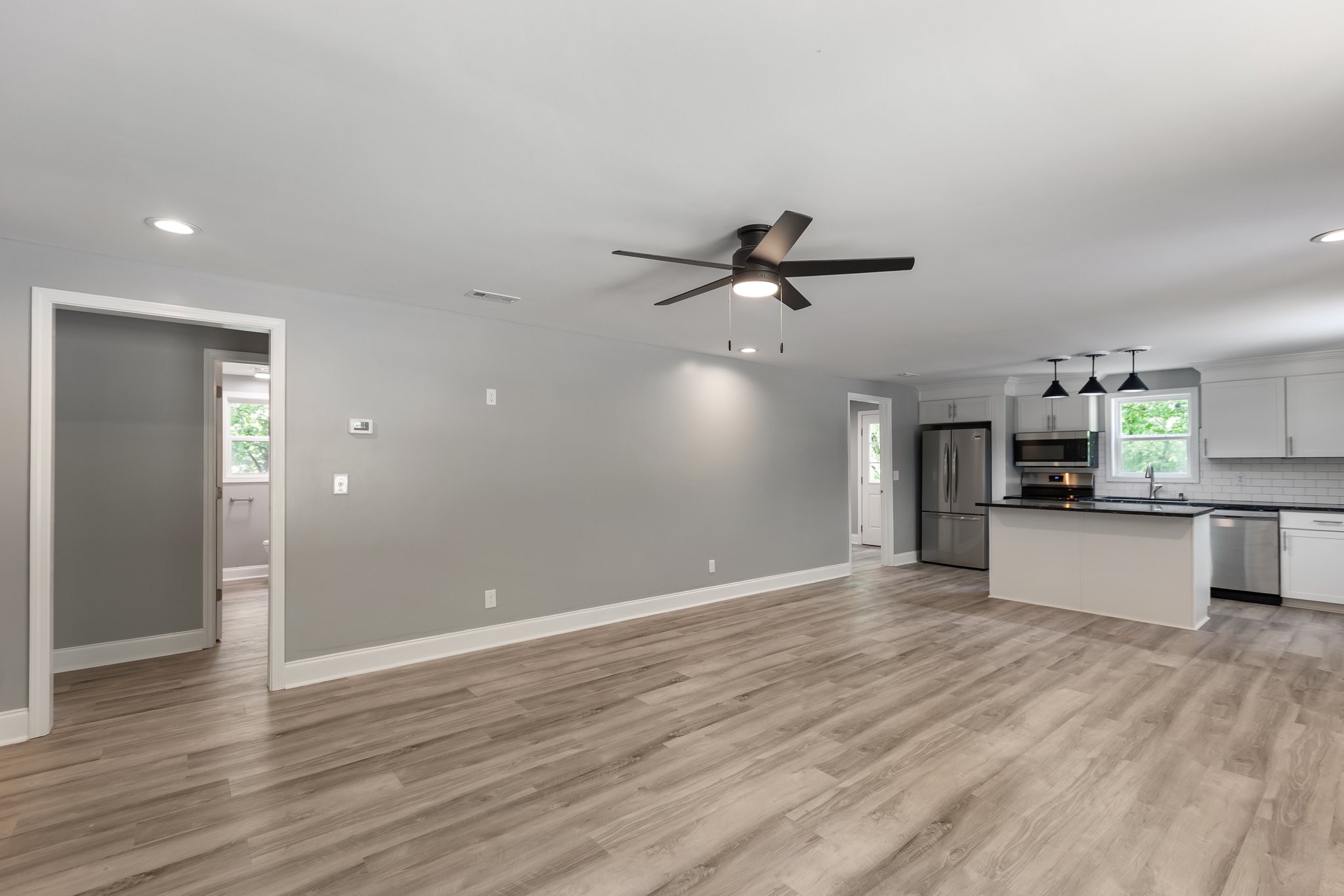 1591 Marsh Creek Road Linden, TN 37096 - Photo 15 of 30 a view of a kitchen with wooden floor and a ceiling fan