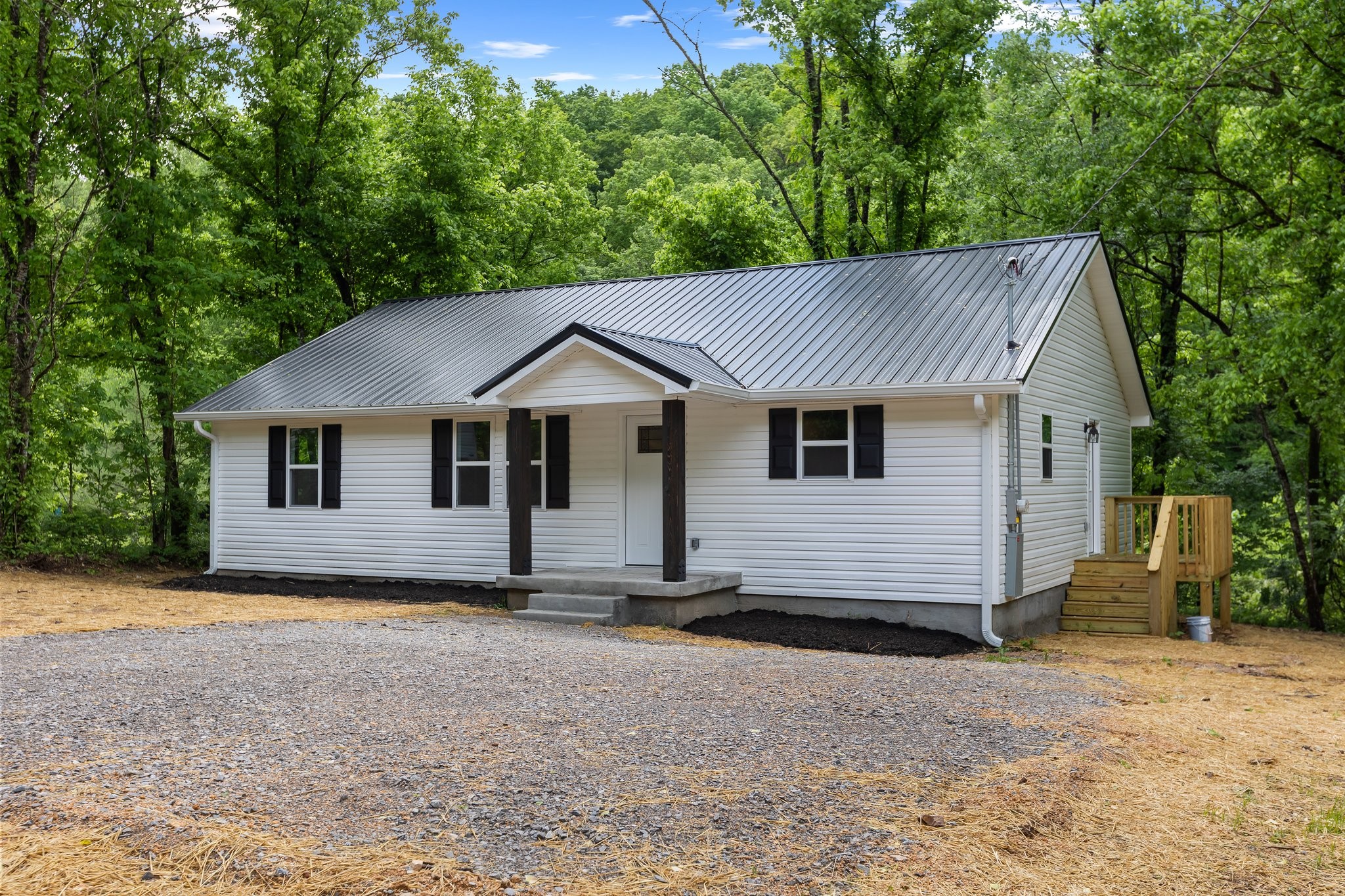 1591 Marsh Creek Road Linden, TN 37096 - Photo 2 of 30 a house with trees in the background