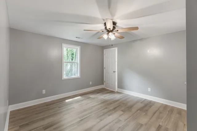 wooden floor in an empty room with a window