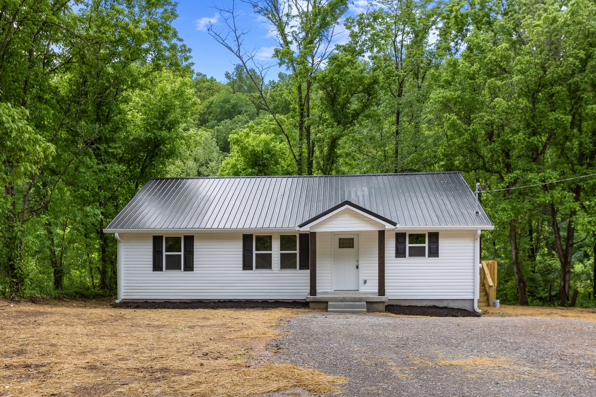 1591 Marsh Creek Road Linden, TN 37096 - Photo 3 of 30 a front view of a house with a garden