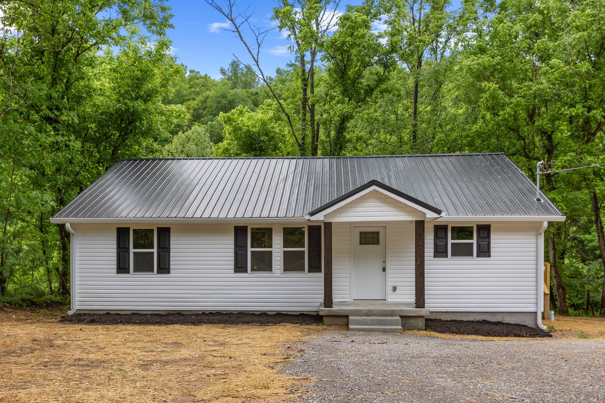1591 Marsh Creek Road Linden, TN 37096 - Photo 4 of 30 a front view of a house with a garden