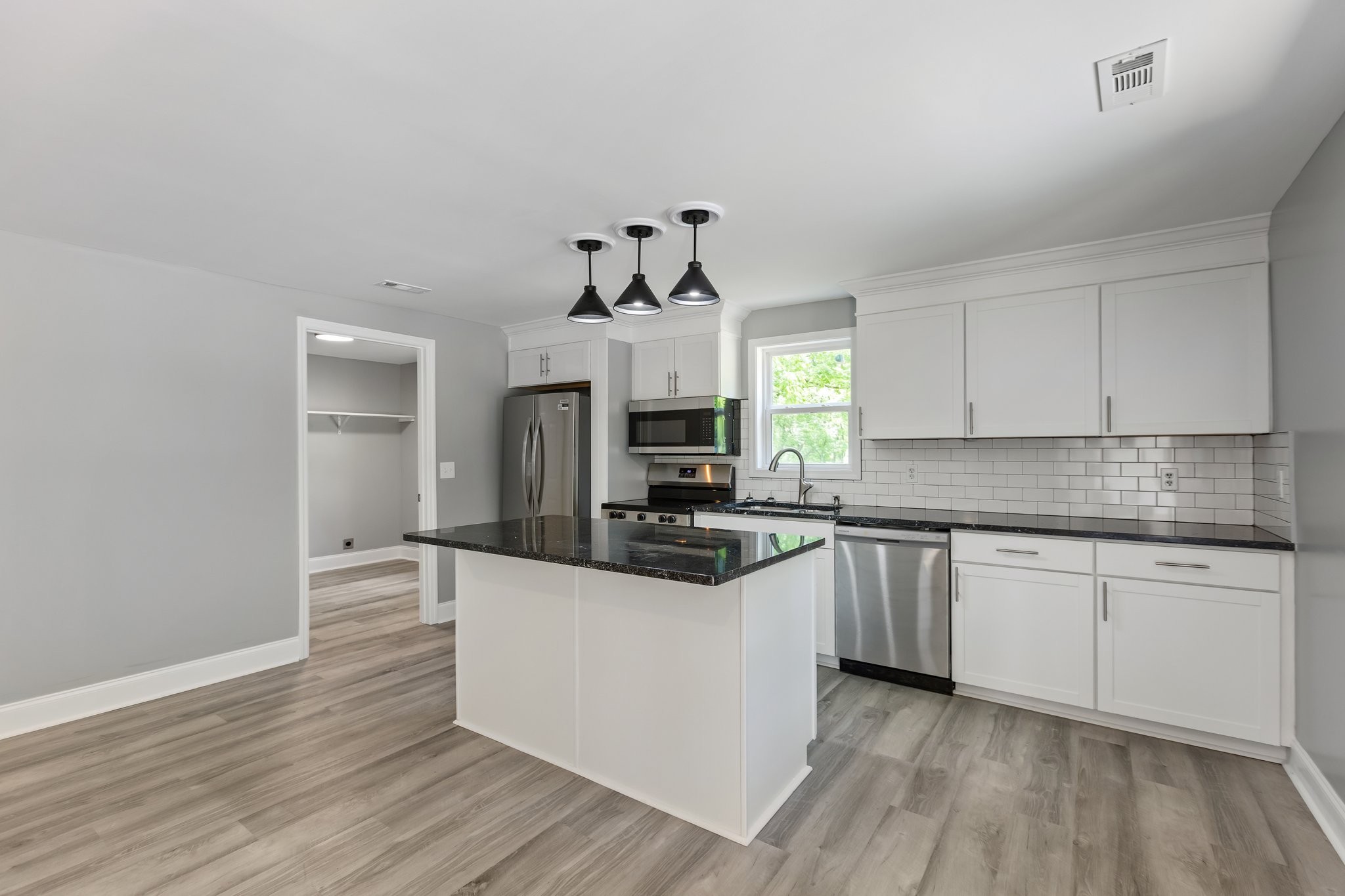 1591 Marsh Creek Road Linden, TN 37096 - Photo 7 of 30 a kitchen with granite countertop a stove and a sink