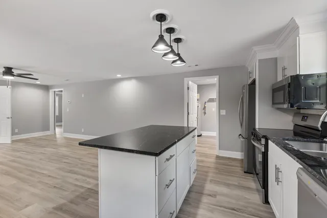 a kitchen with a refrigerator and a sink