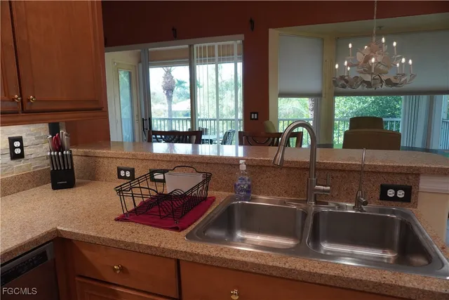 a kitchen counter with a sink and cabinets