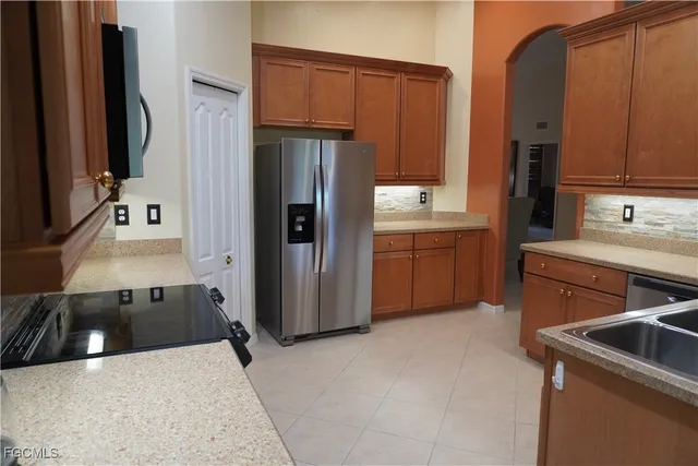 a kitchen with a sink stove and refrigerator