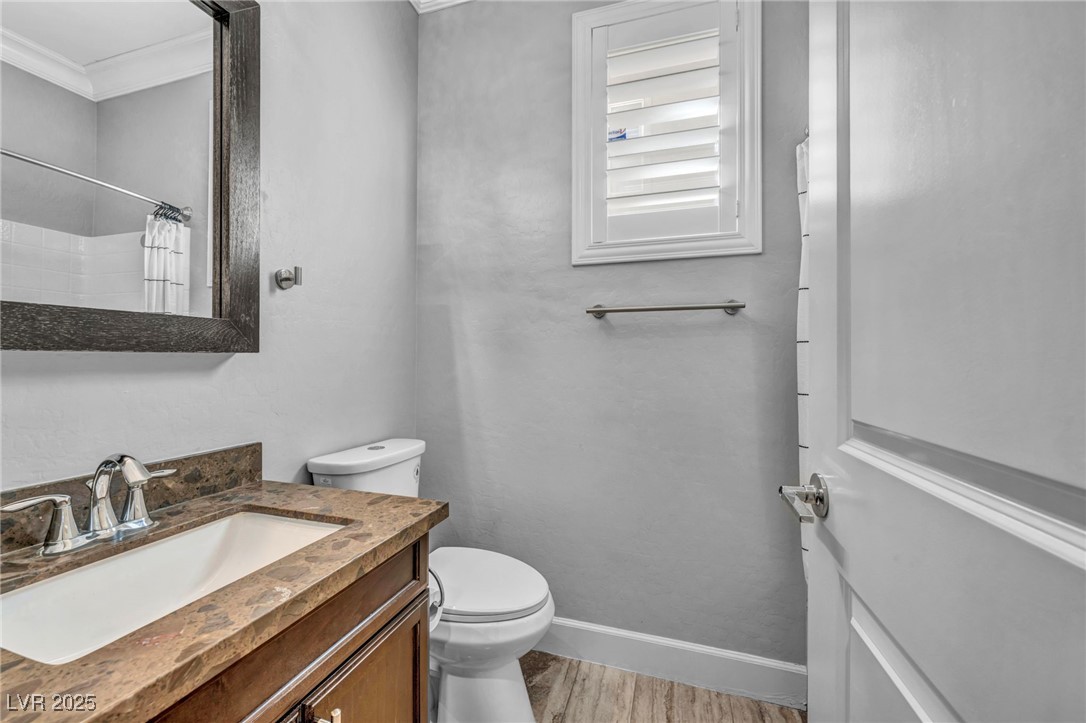 952 McKinley View Avenue Henderson, NV 89012 - Photo 22 of 82 Bathroom with vanity, light wood finished floors, ornamental molding, and a shower with shower curtain