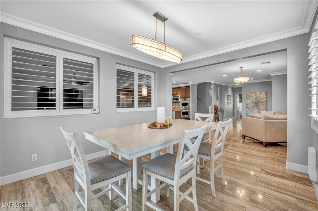 952 McKinley View Avenue Henderson, NV 89012 - Photo 63 of 82 Dining space with ornamental molding and light wood-type flooring