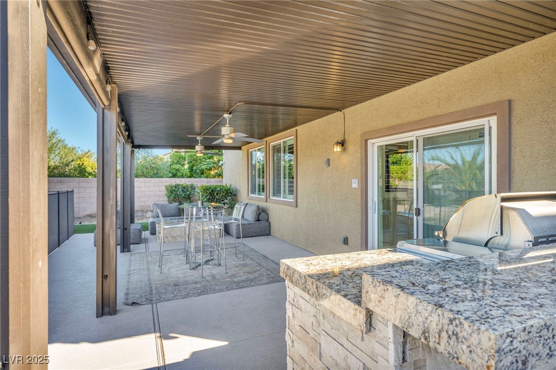 952 McKinley View Avenue Henderson, NV 89012 - Photo 70 of 82 Fenced backyard featuring a patio area, outdoor dining space, ceiling fan, area for grilling, and outdoor lounge area