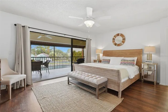 a bedroom with a bed and a large window