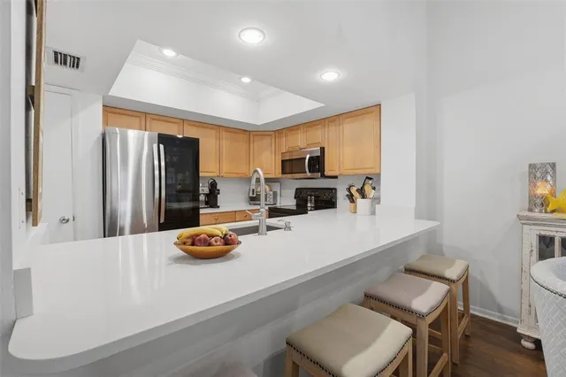 a kitchen with a table chairs stove and refrigerator