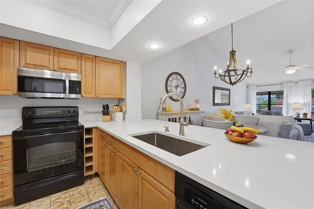 a kitchen with a sink a stove and cabinets