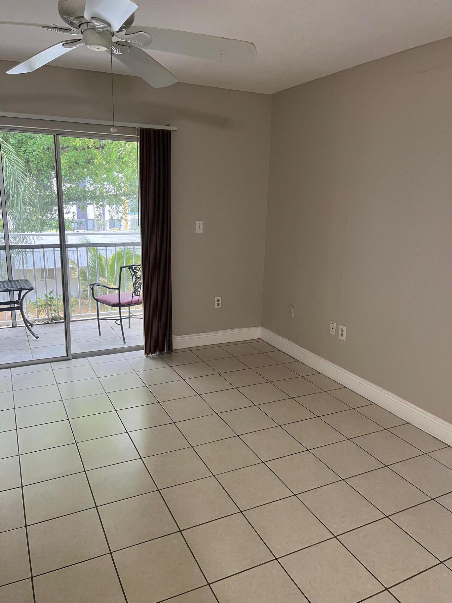 11307 Southwest 200th Street, Unit 313B Miami, FL 33157 - Photo 5 of 8 en empty room with sliding glass door