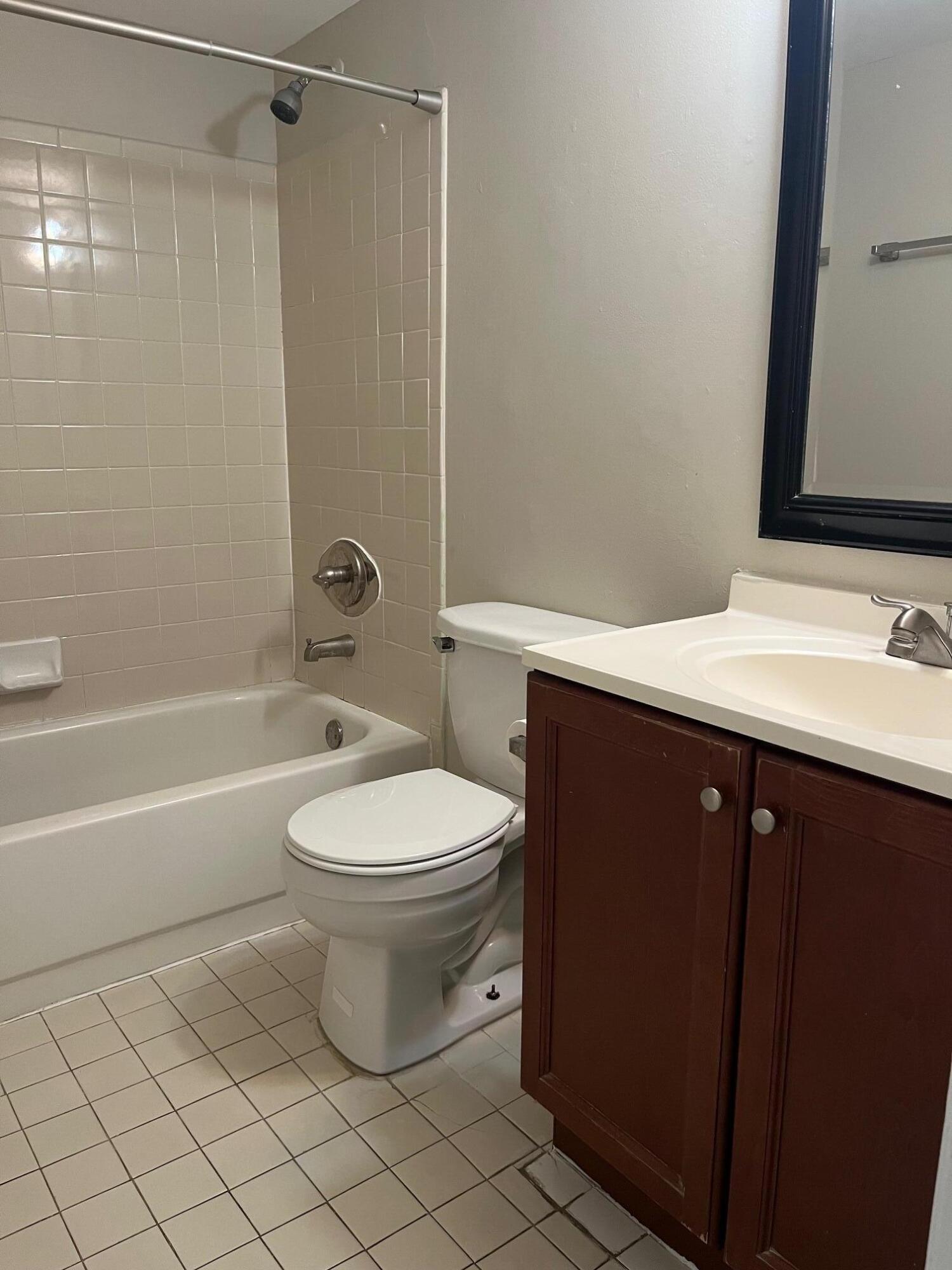 11307 Southwest 200th Street, Unit 313B Miami, FL 33157 - Photo 7 of 8 a bathroom with a sink a toilet and shower