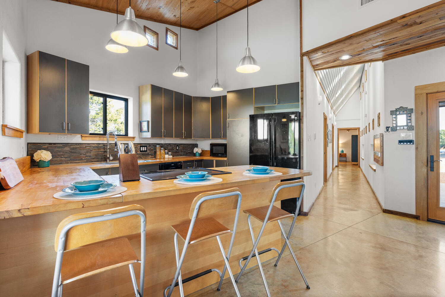 650 Angel Fire Drive Dripping Springs, TX 78620 - Photo 11 of 40 a dining table chairs and a refrigerator