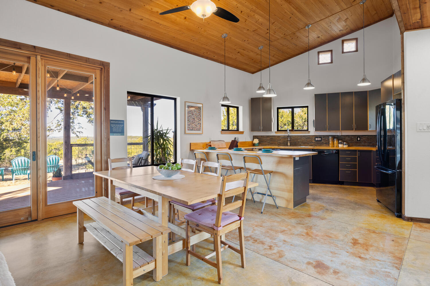 650 Angel Fire Drive Dripping Springs, TX 78620 - Photo 8 of 40 a dining hall with stainless steel appliances granite countertop a stove top oven a sink a dining table and chairs