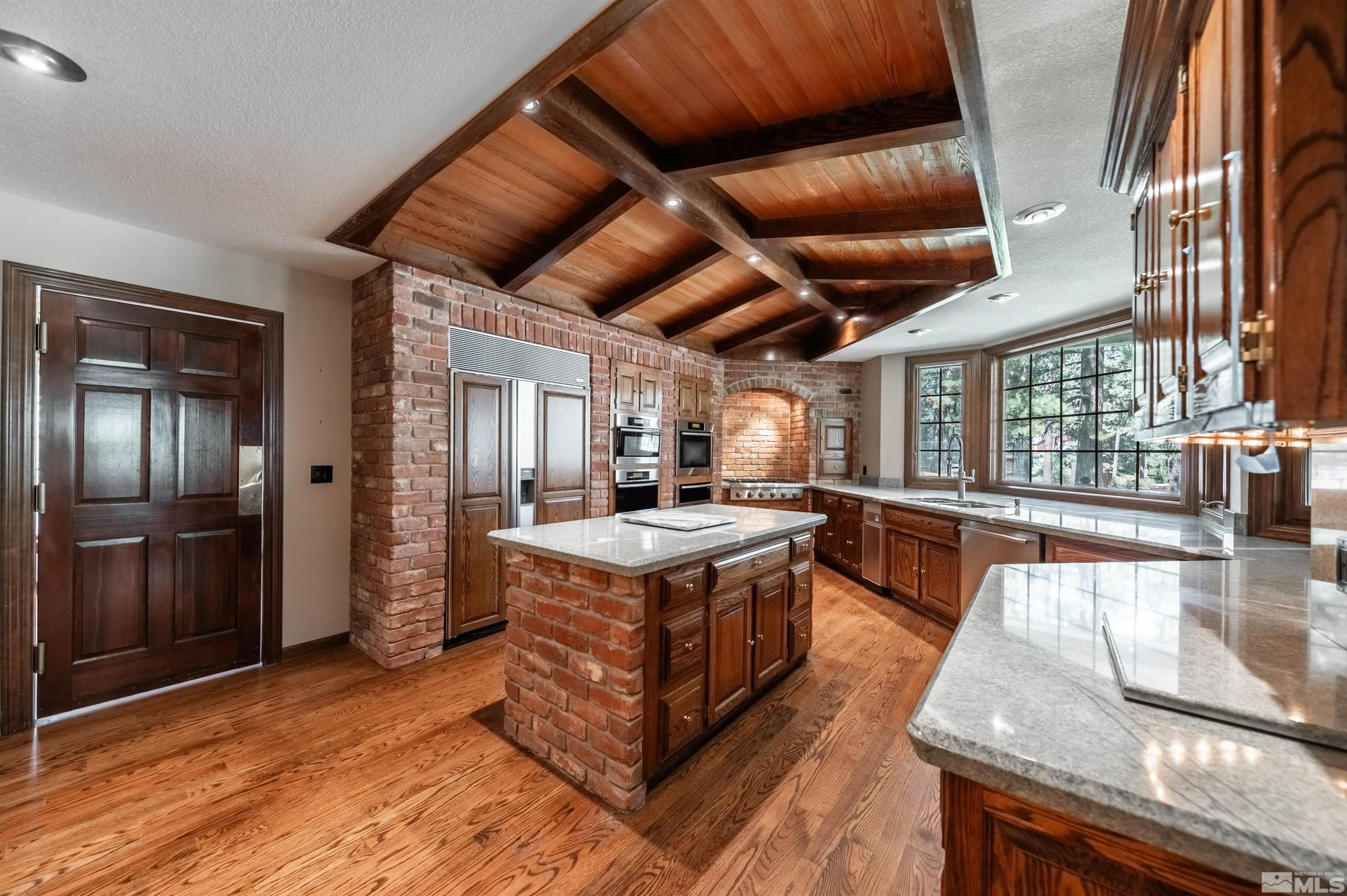 7250 Franktown Road Washoe Valley, NV 89704 - Photo 11 of 40 a kitchen with stainless steel appliances granite countertop a stove and a refrigerator