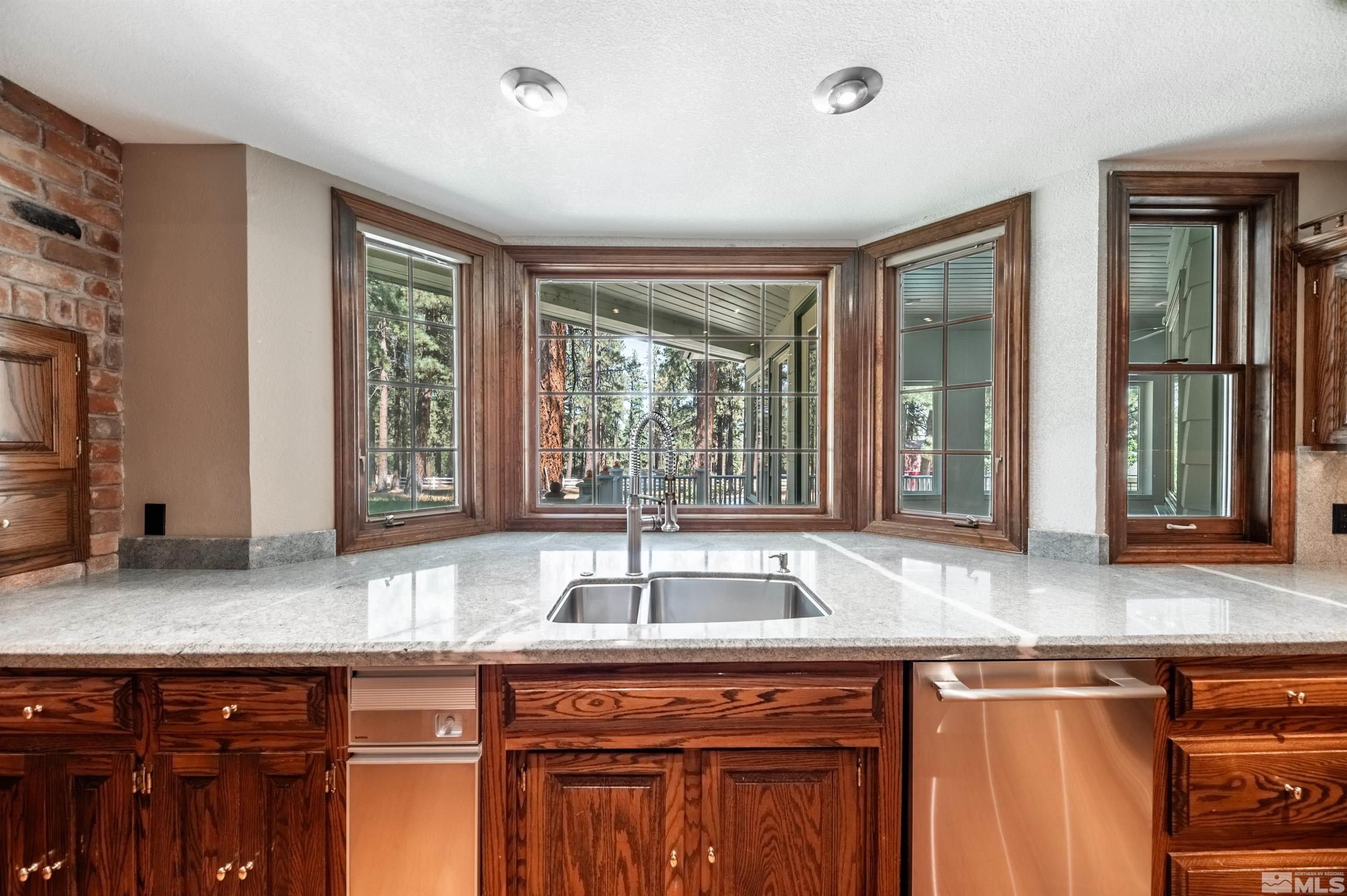 7250 Franktown Road Washoe Valley, NV 89704 - Photo 13 of 40 a kitchen with granite countertop a sink and a window