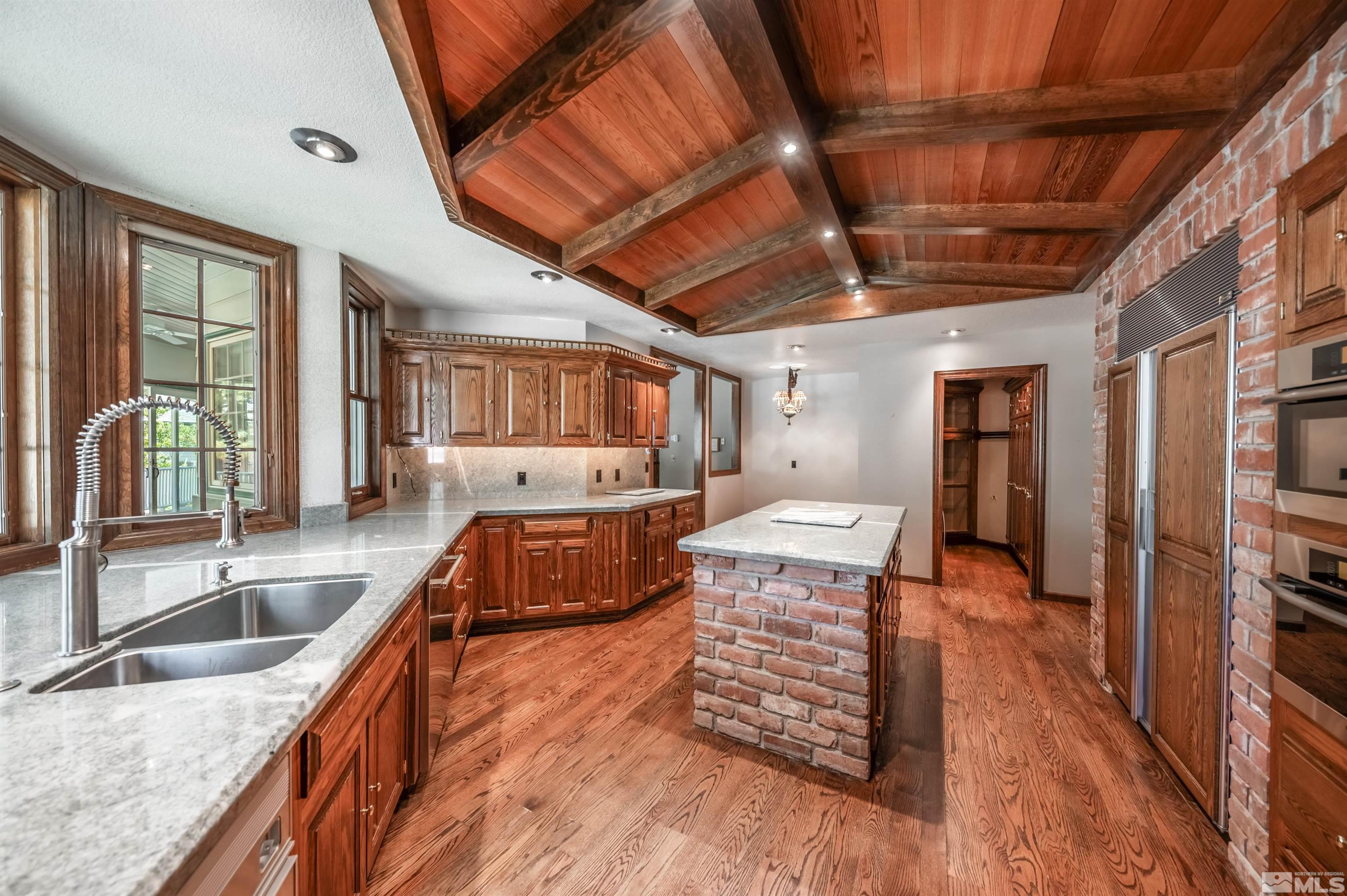 7250 Franktown Road Washoe Valley, NV 89704 - Photo 14 of 40 a kitchen with granite countertop a sink a counter space and stainless steel appliances