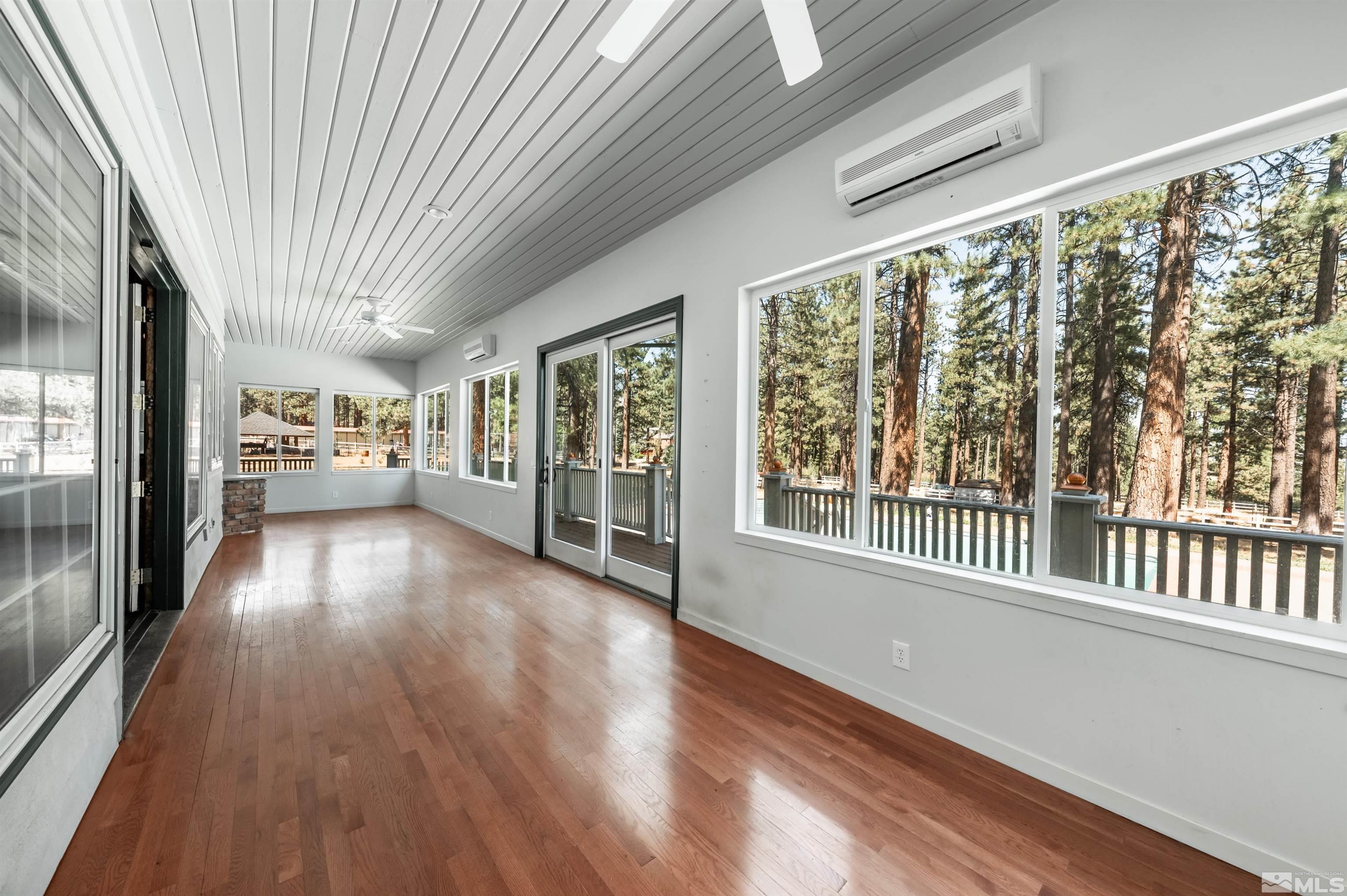 7250 Franktown Road Washoe Valley, NV 89704 - Photo 18 of 40 a view of an empty room with wooden floor and a window
