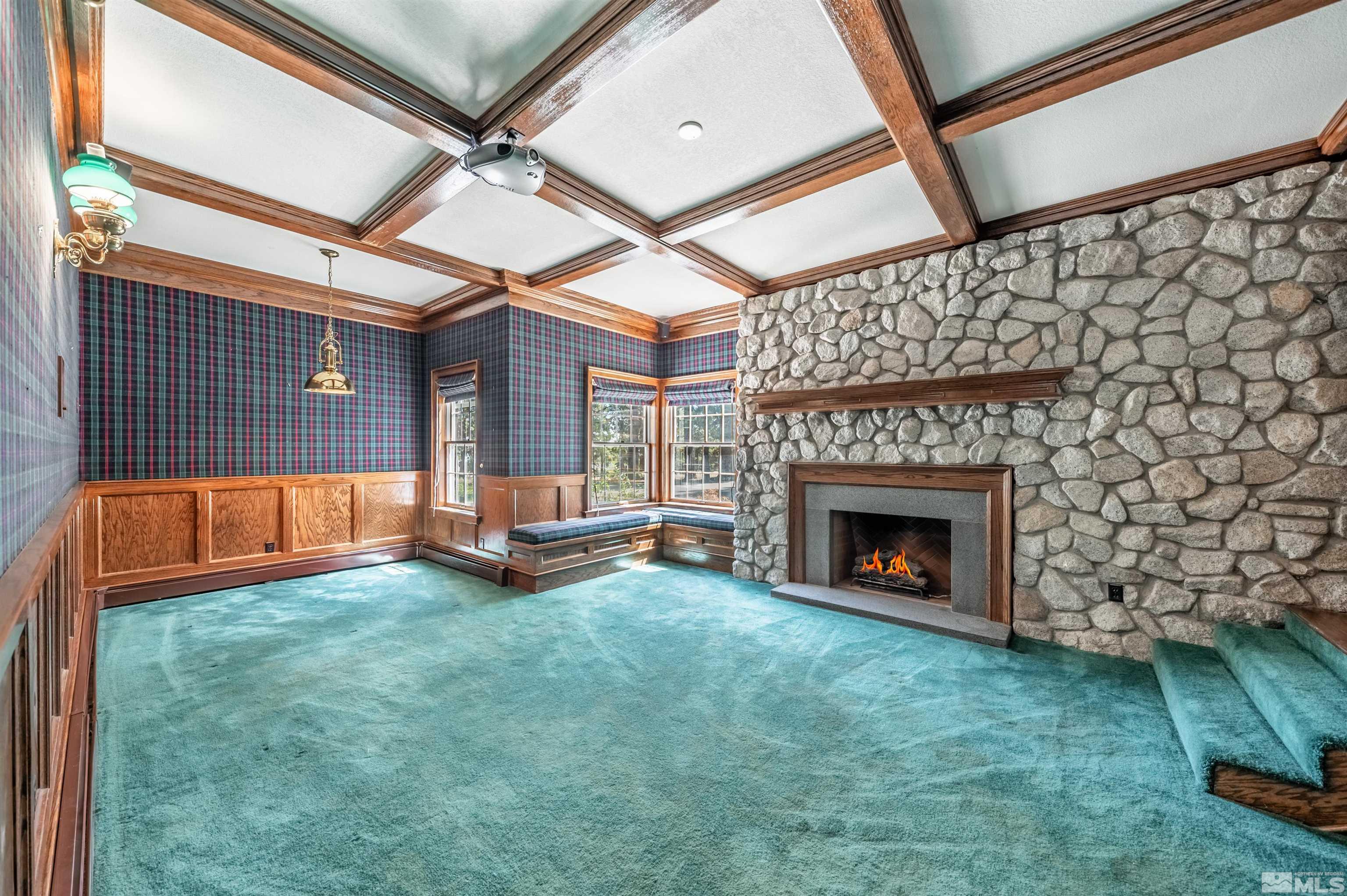 7250 Franktown Road Washoe Valley, NV 89704 - Photo 19 of 40 a view of an empty room with wooden floor fireplace and a window