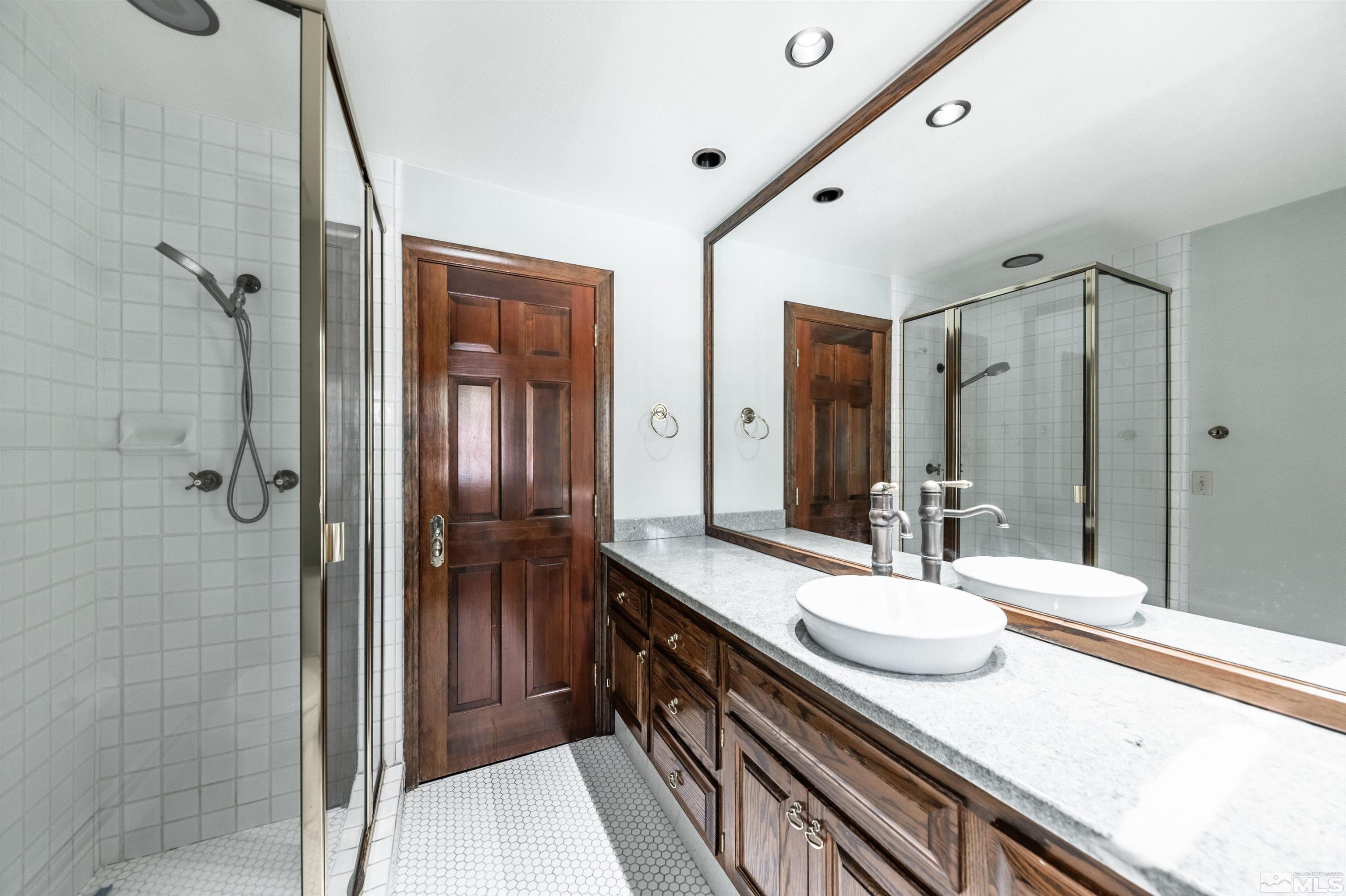 7250 Franktown Road Washoe Valley, NV 89704 - Photo 20 of 40 a spacious bathroom with a granite countertop sink mirror and shower