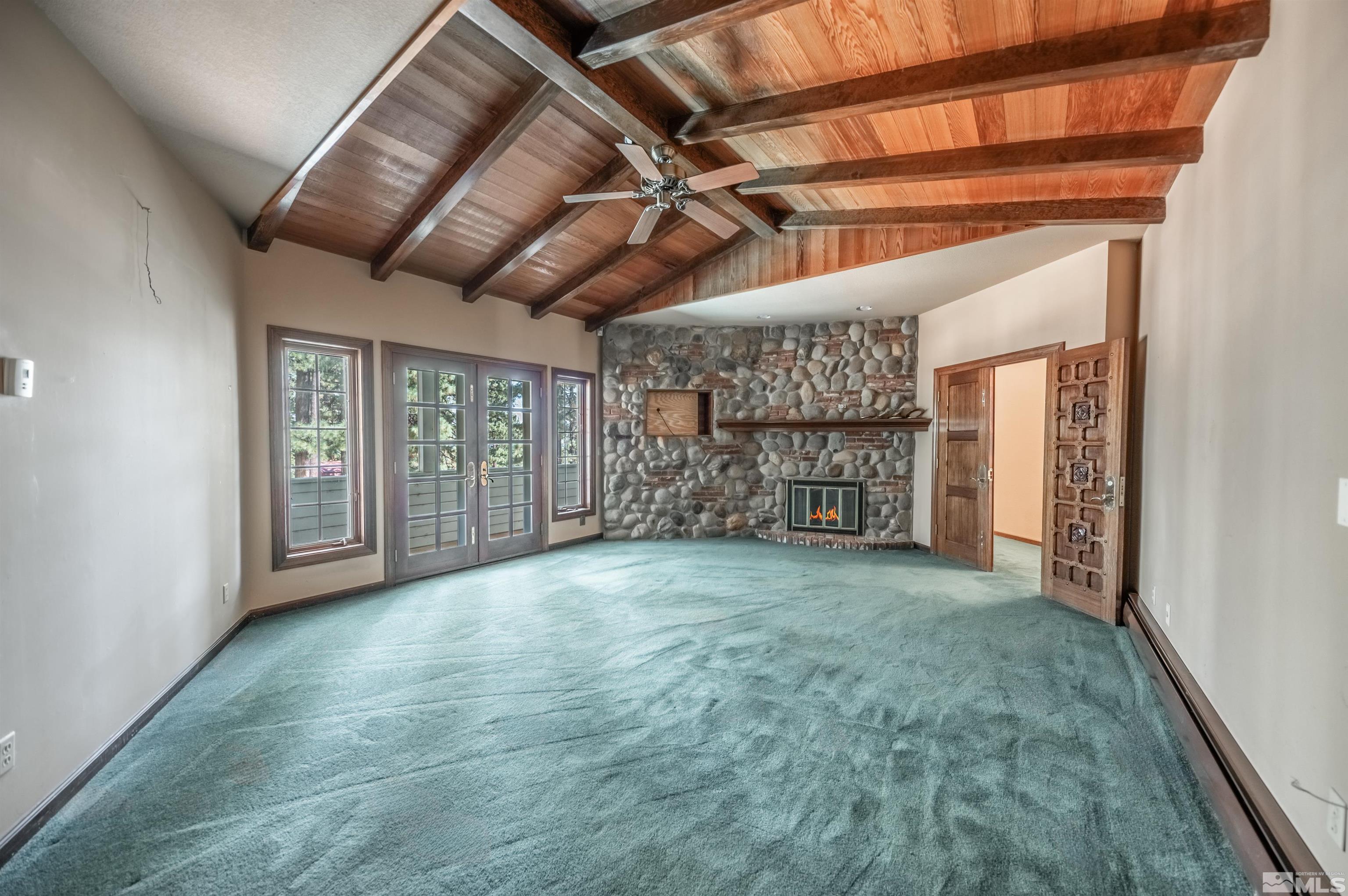 7250 Franktown Road Washoe Valley, NV 89704 - Photo 22 of 40 a view of an empty room with a fireplace and a window