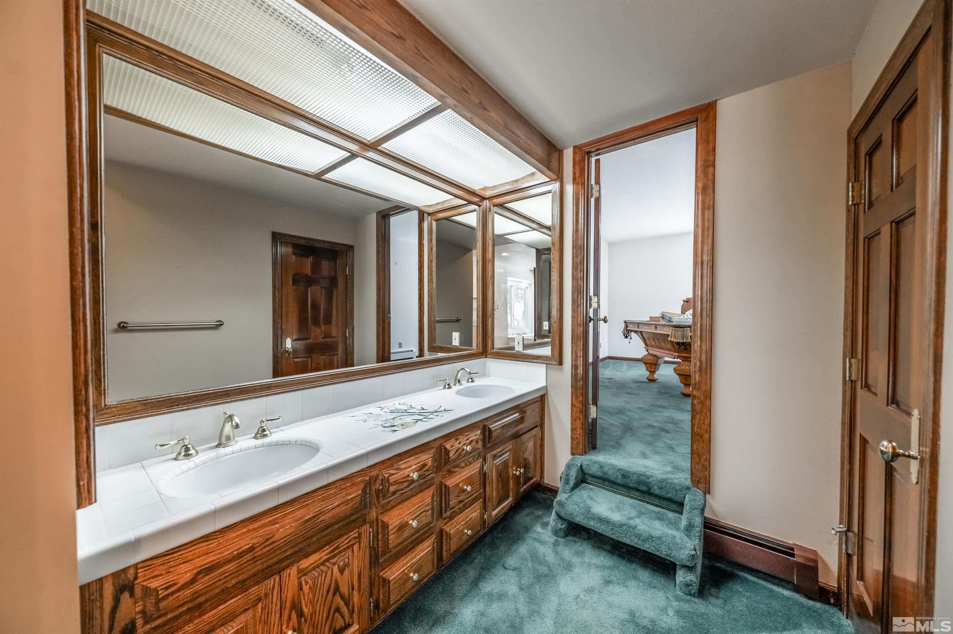 7250 Franktown Road Washoe Valley, NV 89704 - Photo 25 of 40 a spacious bathroom with a double vanity sink and a mirror