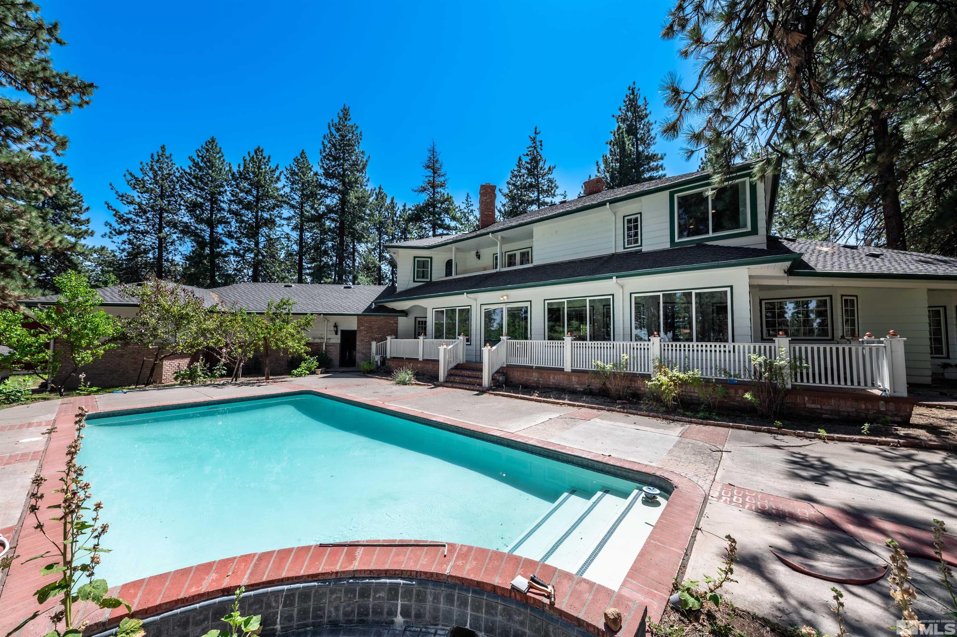 7250 Franktown Road Washoe Valley, NV 89704 - Photo 30 of 40 a view of a house with pool fire pit a patio and a yard