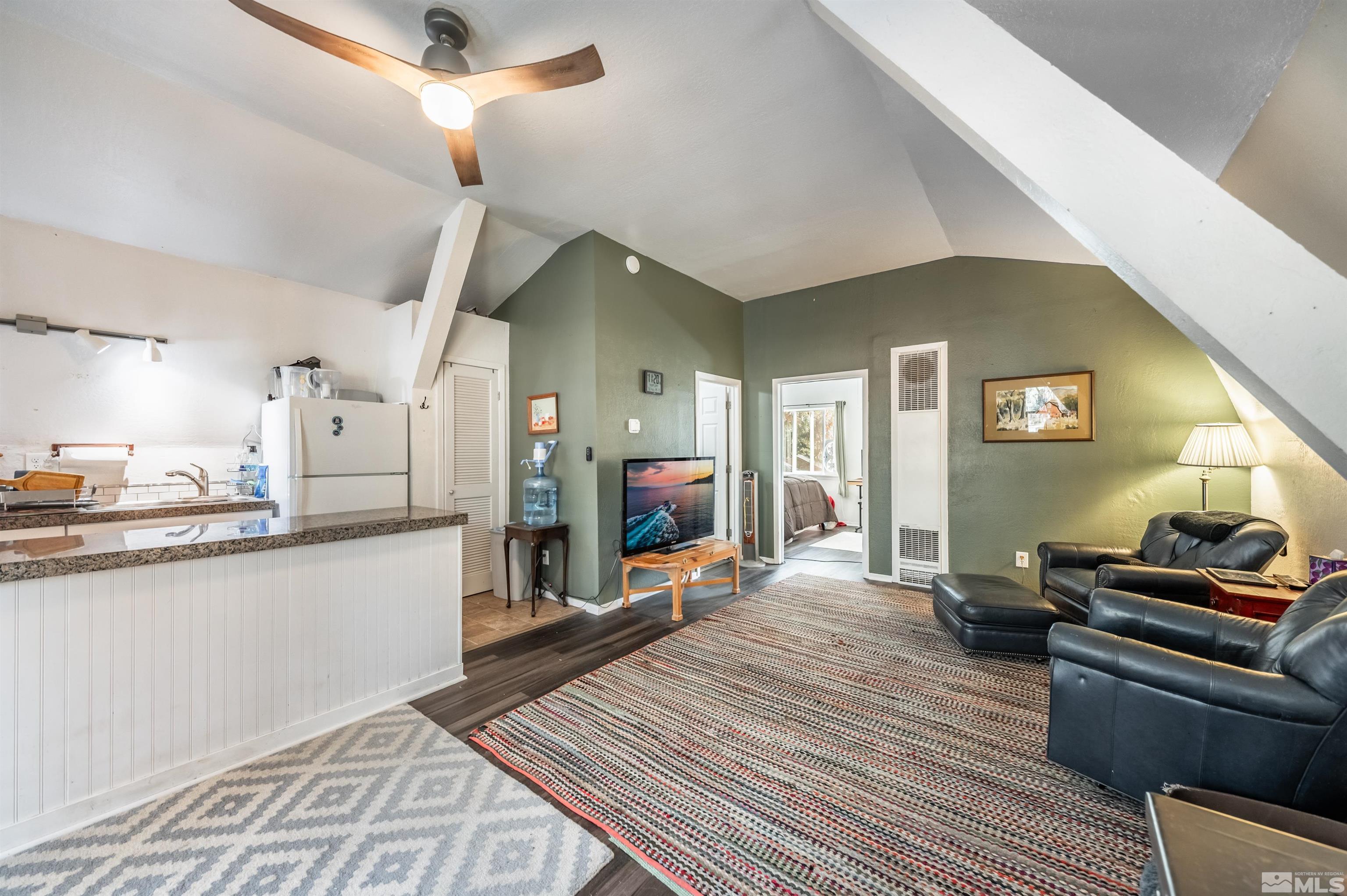 7250 Franktown Road Washoe Valley, NV 89704 - Photo 37 of 40 a large living room with stainless steel appliances granite countertop furniture a fireplace and a chandelier