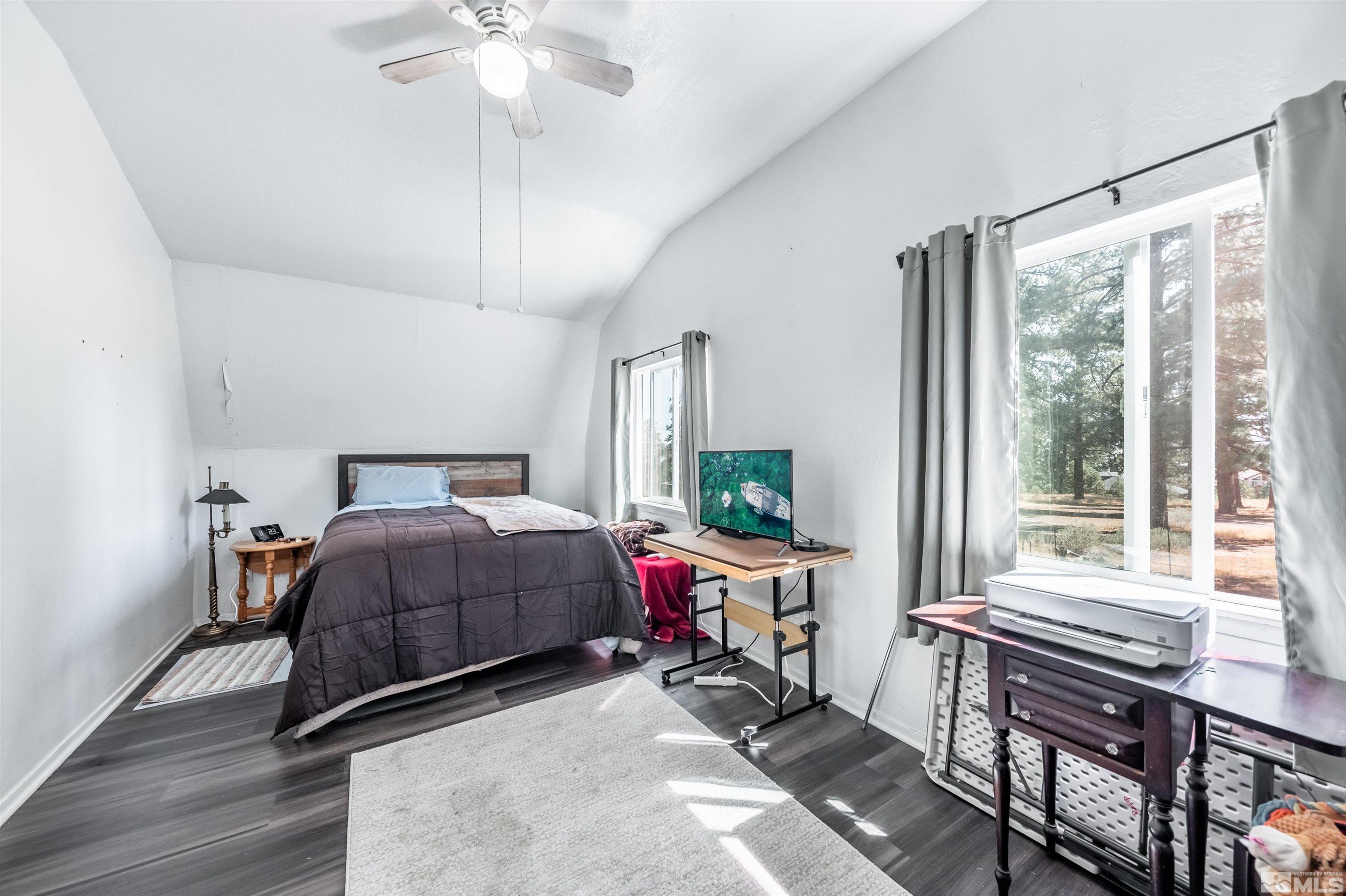 7250 Franktown Road Washoe Valley, NV 89704 - Photo 39 of 40 a bedroom with a bed and a chandelier