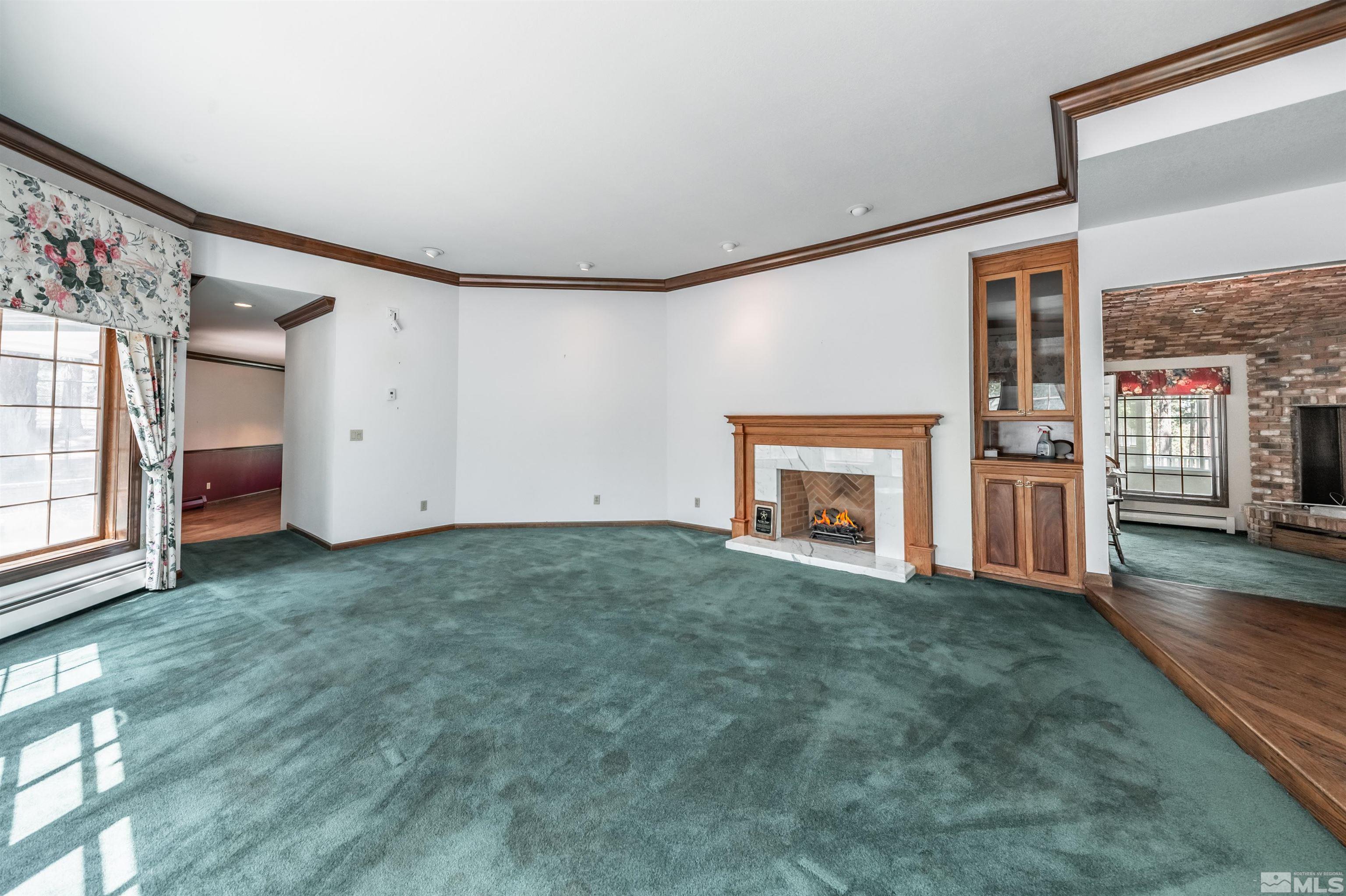 7250 Franktown Road Washoe Valley, NV 89704 - Photo 8 of 40 a view of empty room with fireplace and wooden floor