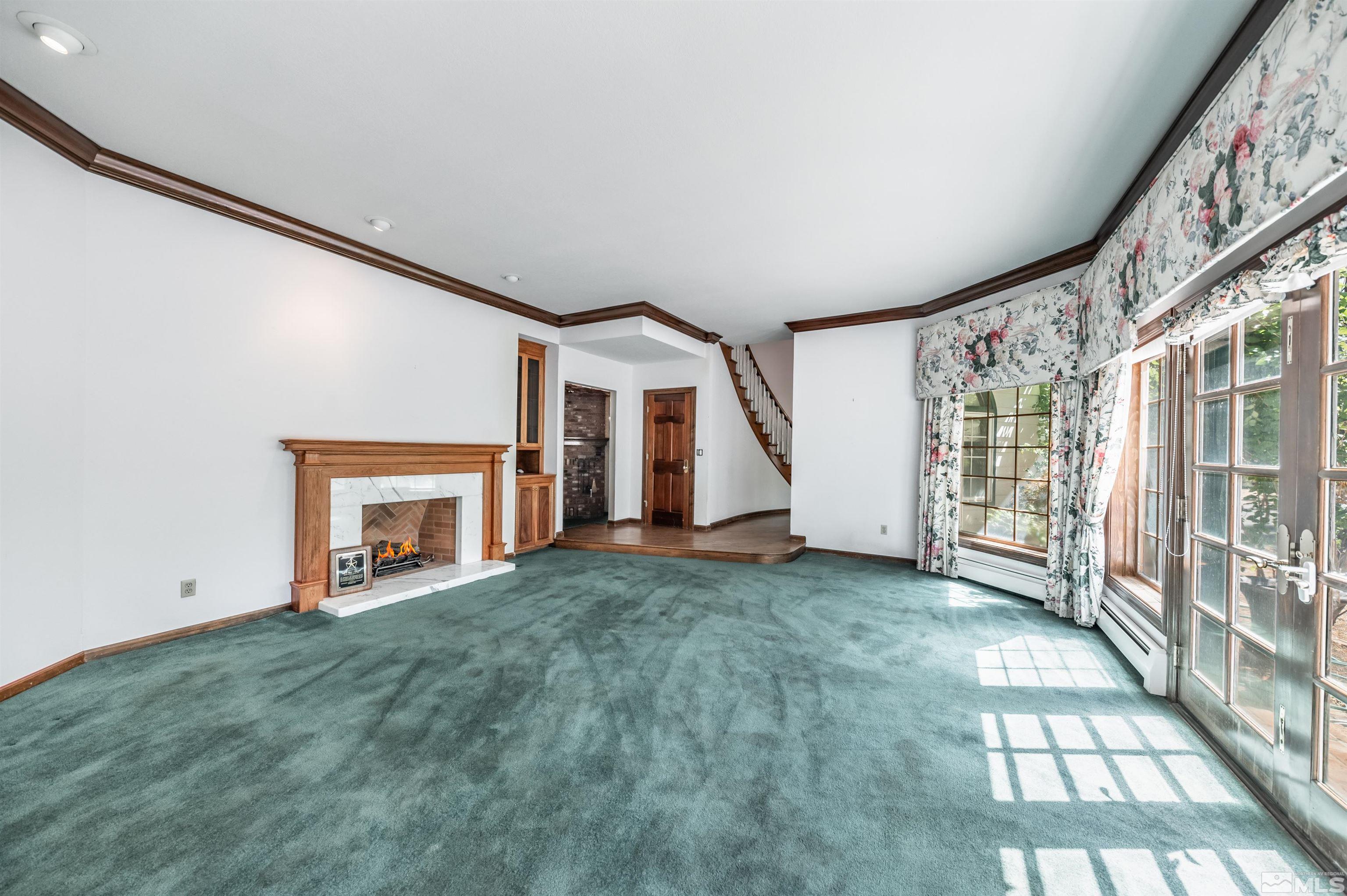 7250 Franktown Road Washoe Valley, NV 89704 - Photo 9 of 40 a view of an empty room with a fireplace and a window
