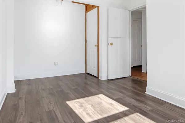 an empty room with wooden floor