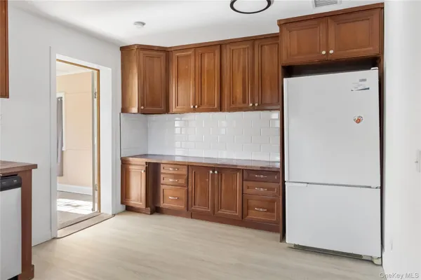 a kitchen with a refrigerator and cabinets